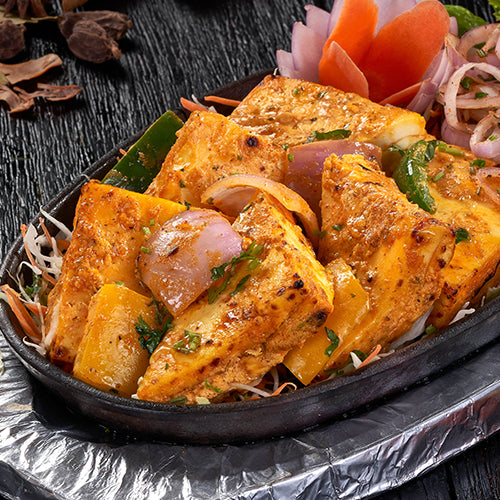 A delectable dish of Achari Paneer Tikka, paneer cubes marinated in yogurt and spices