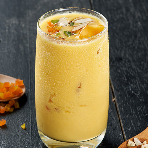Refreshing Mango Lassi, a creamy blend of mangoes, yogurt, and spices, a perfect thirst quencher at Ganesha Ek Sanskriti Indian Restaurant