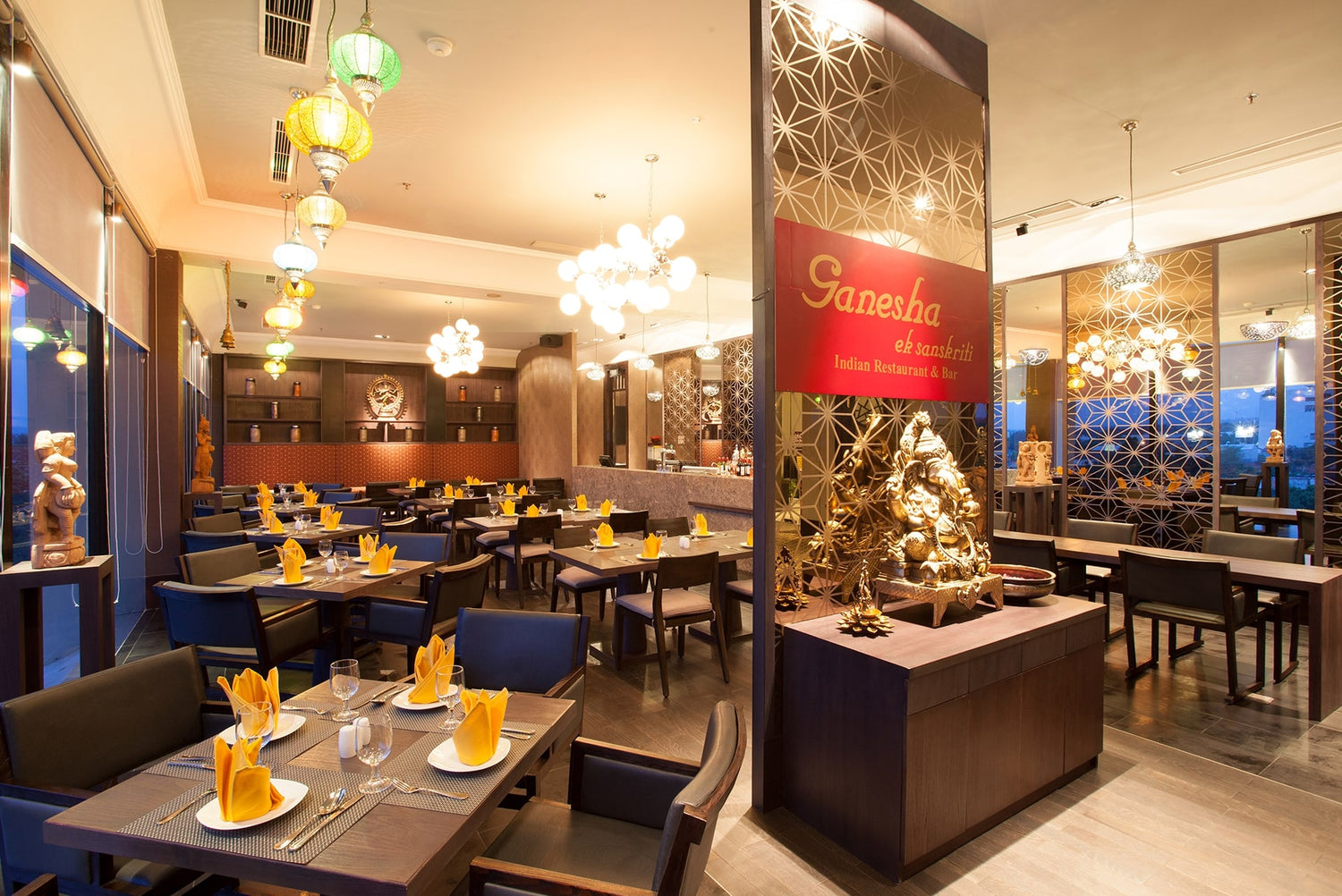 A vibrant dining room with traditional Indian décor at Ganesha Ek Sanskriti, an authentic Indian Restaurant in Yogyakarta.