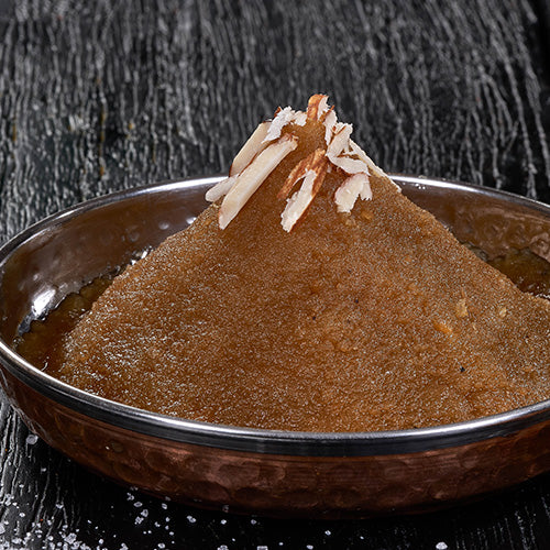 A sweet and nutty Indian pudding, Moong Dal Halwa, made with lentils, cardamom, and sugar