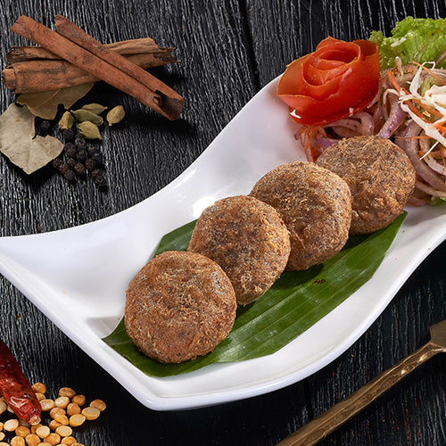 A plate of crispy Shami Kebabs, savory patties made with minced lamb and lentil