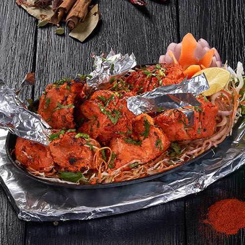 A whole Tandoori Murgh marinated in yogurt and spices