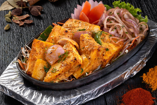A delectable dish of Achari Paneer Tikka, paneer cubes marinated in yogurt and spices