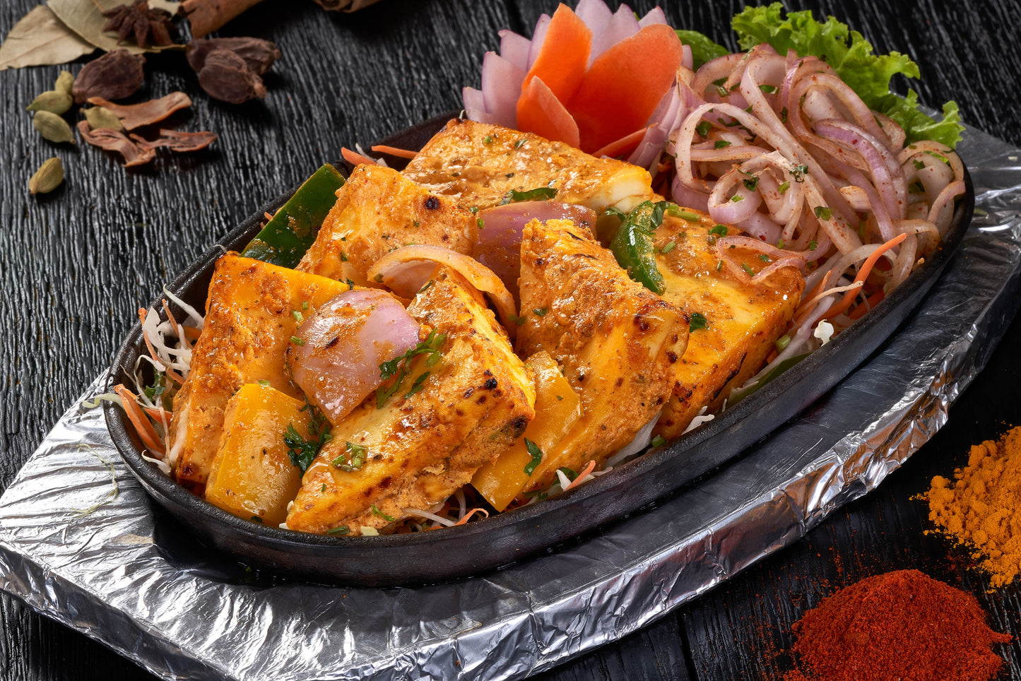 A delectable dish of Achari Paneer Tikka, paneer cubes marinated in yogurt and spices