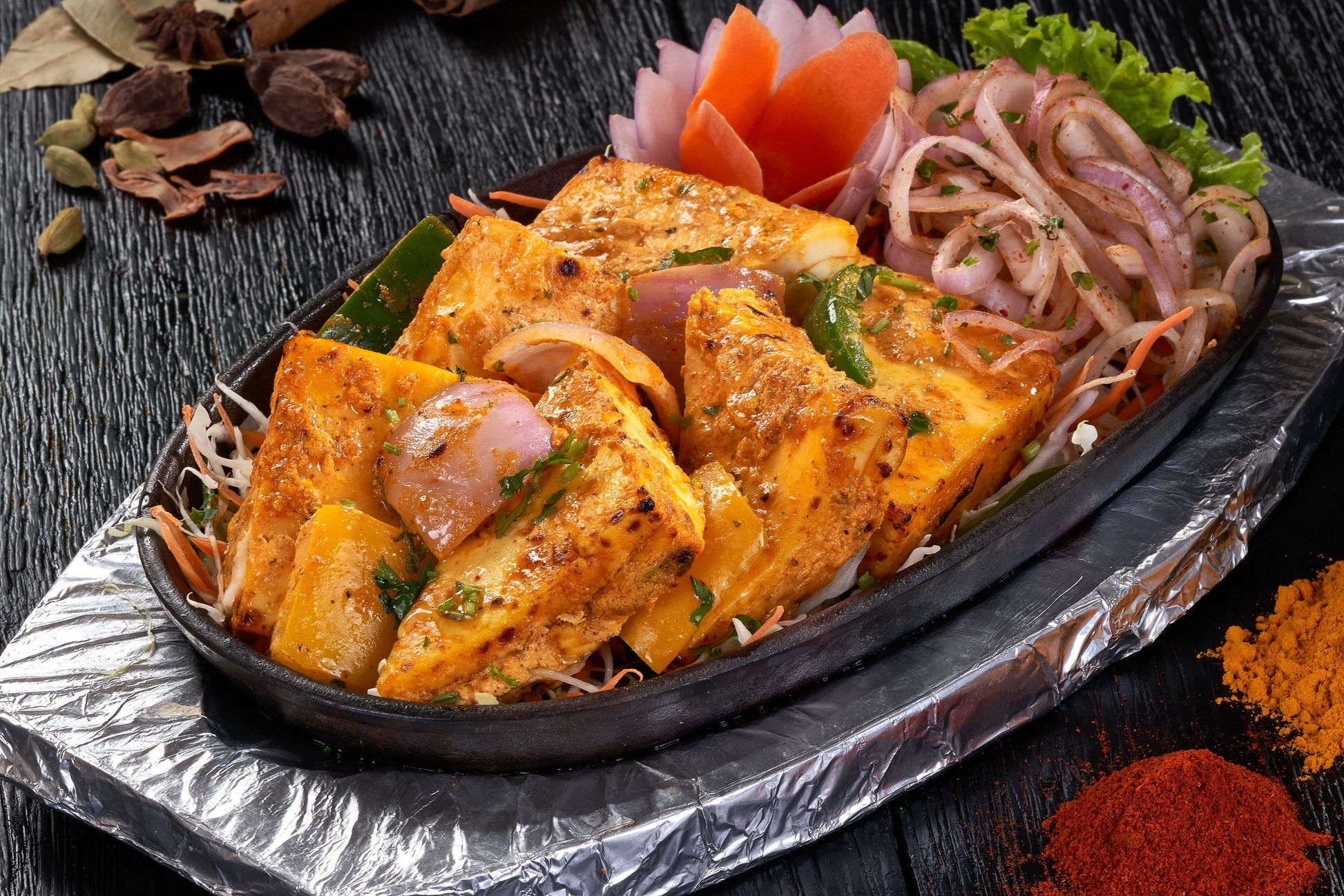 A delectable dish of Achari Paneer Tikka, paneer cubes marinated in yogurt and spices