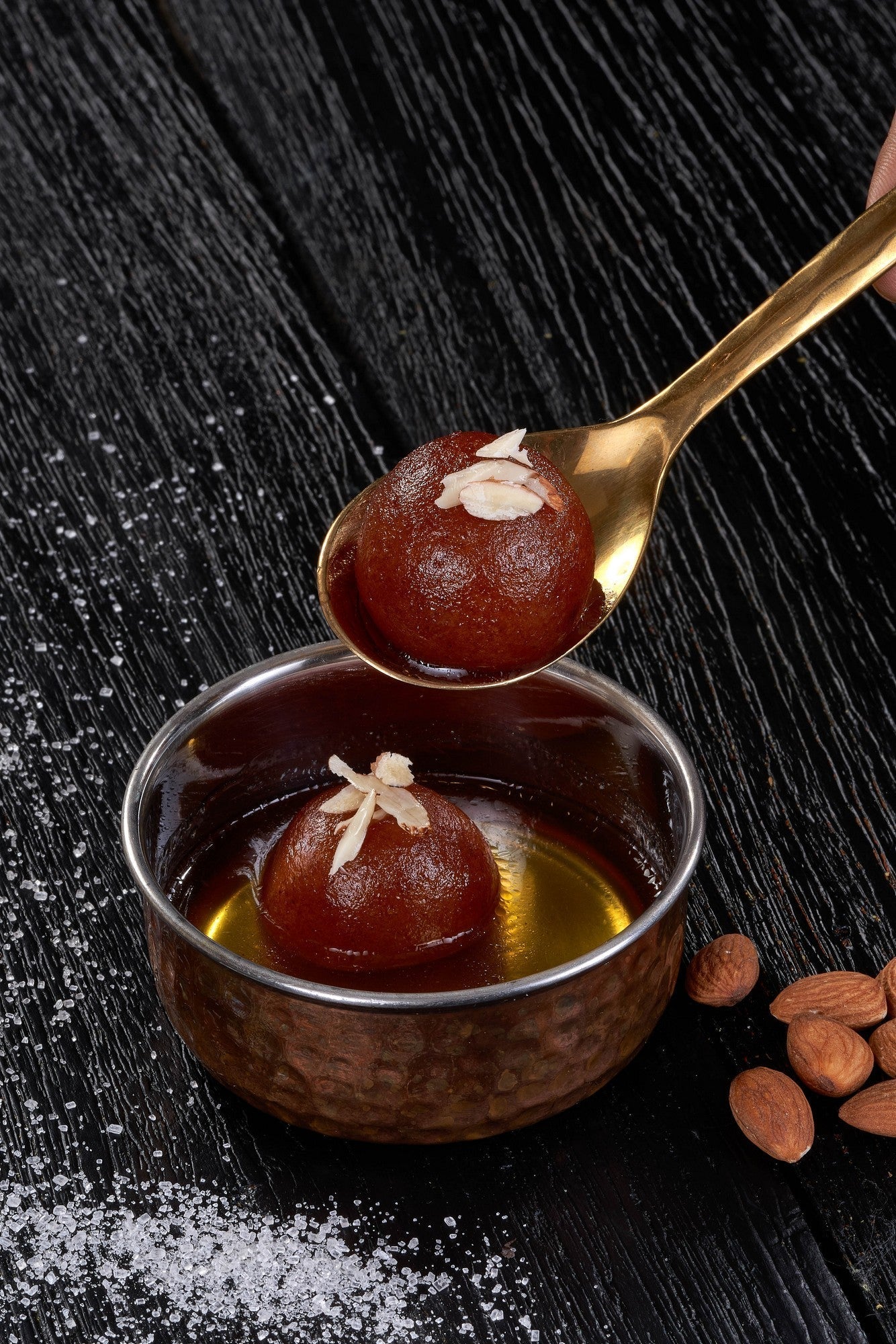 Gulab Jamun, a classic Indian dessert with a soft, spongy texture and a sweet, syrupy coating