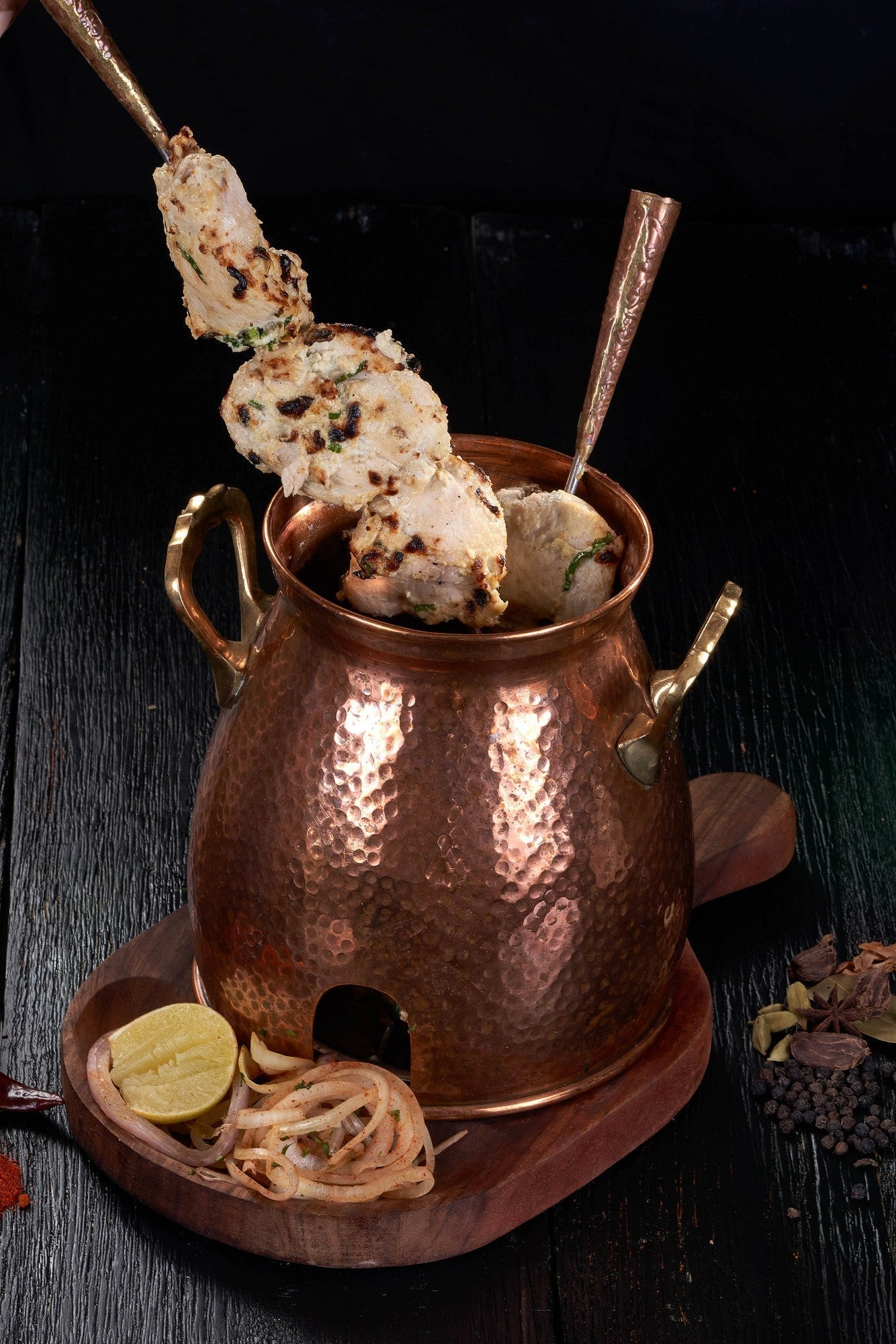 Tender pieces of Murgh Malai Tikka, marinated in yogurt, cheese, and garlic, at an Indian Restaurant