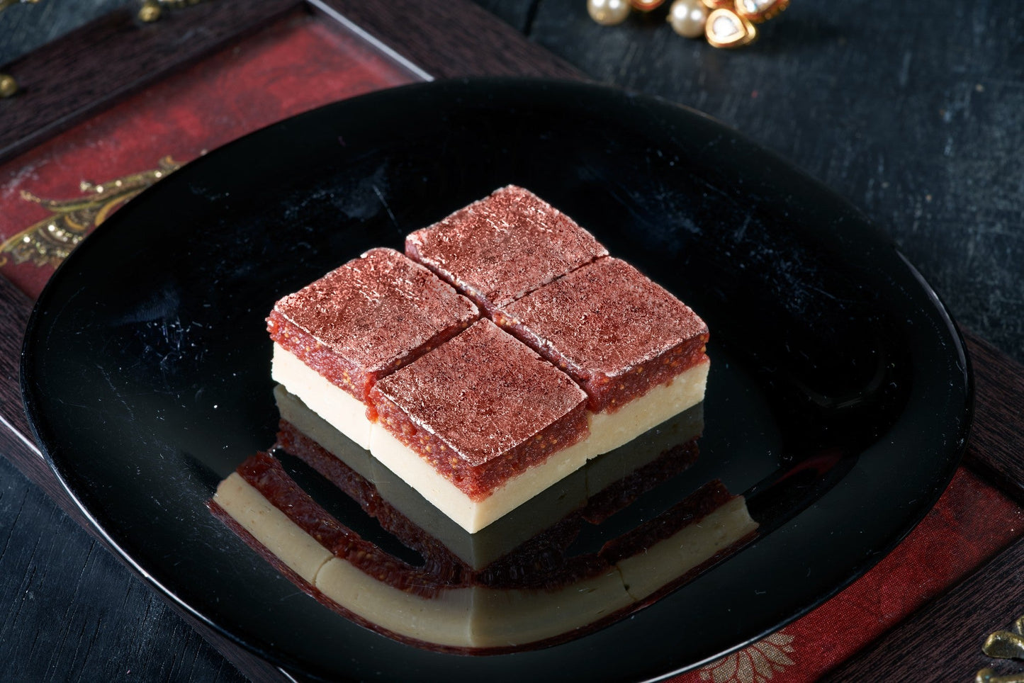 A delectable Indian dessert, Anjeer Burfi, made with dried figs, nuts, and spices, cut into diamond-shaped pieces
