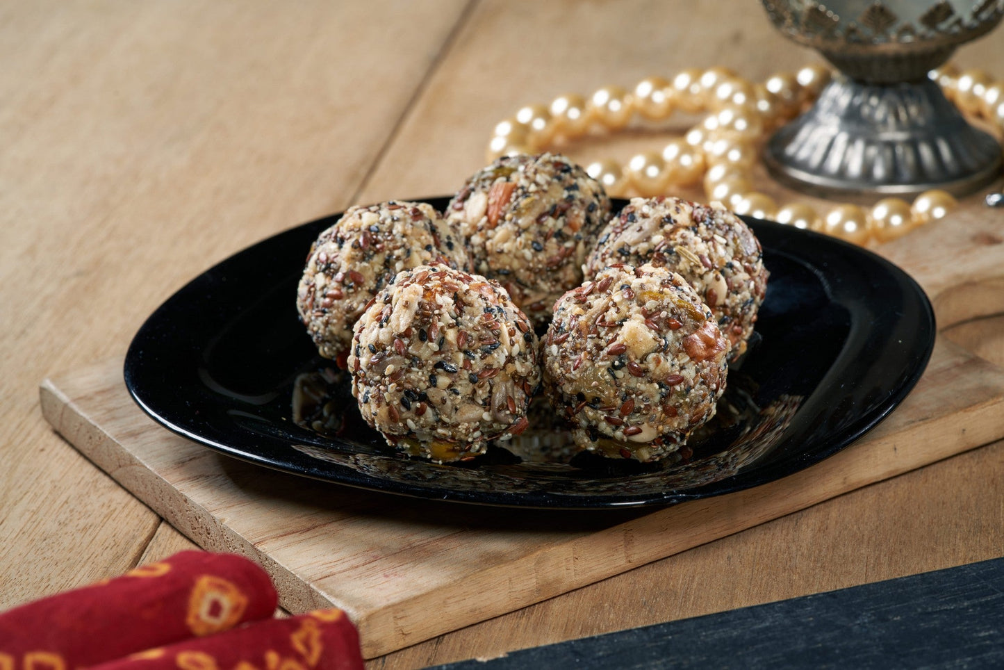 A delightful Indian sweet, Dry Fruit Ladoo, made with a mixture of nuts, fruits, and spices, rolled into bite-sized balls