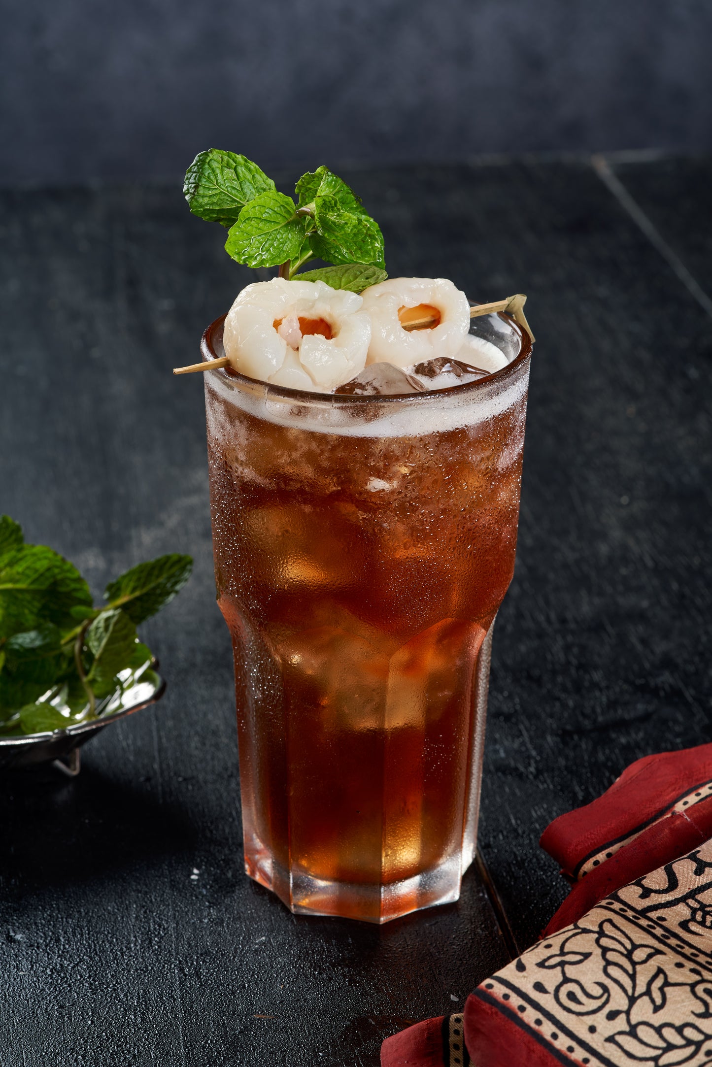 A refreshing glass of Lychee Tea, a sweet and tangy Indian drink made with lychees and spices