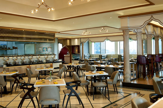 A spacious dining room with tables and chairs at Ganesha Ek Sanskriti, an Indian Restaurant located in Ganesha BRI II (Jakarta).