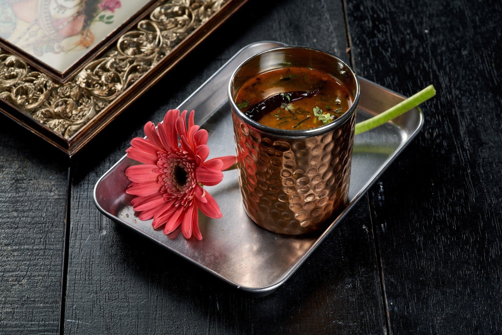 A steaming bowl of Rasam, a traditional South Indian soup known for its tangy and spicy flavors