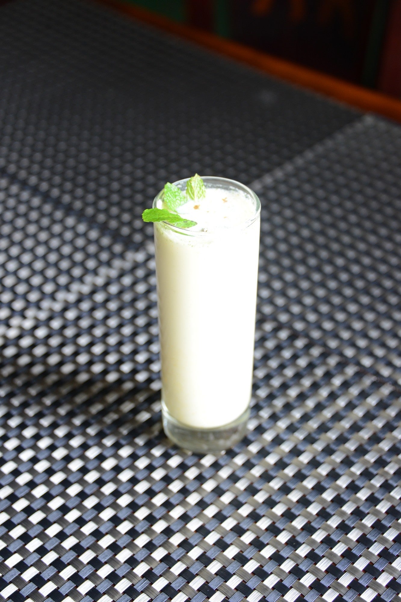 A refreshing glass of Masala Chaas, a traditional Indian yogurt drink made with homemade yogurt, coriander, ginger, and Indian spices